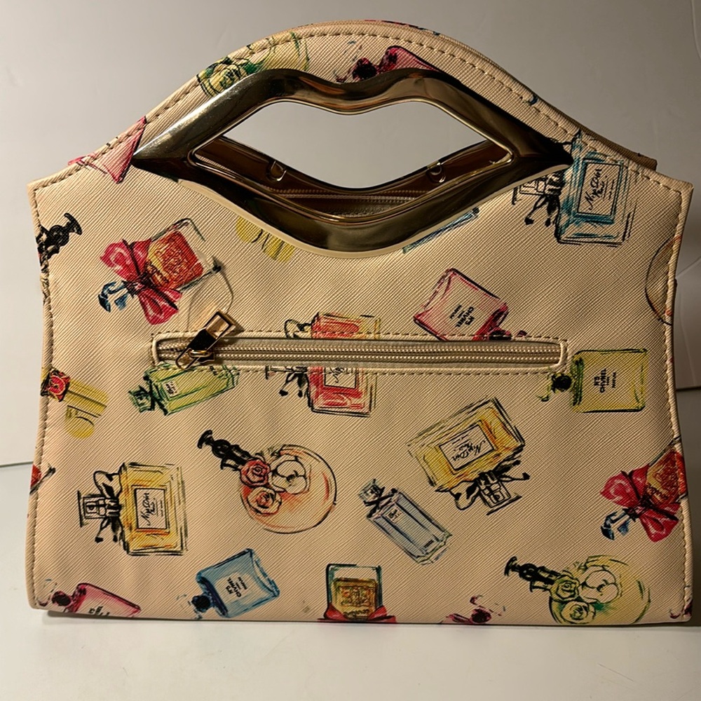 Khaki colored with perfume bottles and lips handle With gold colored hardware